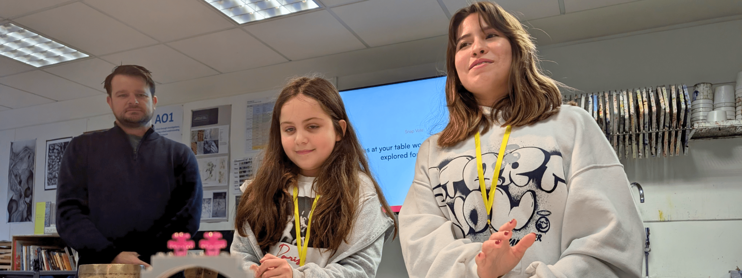 Two girls Two girls standing in a classroom smiling