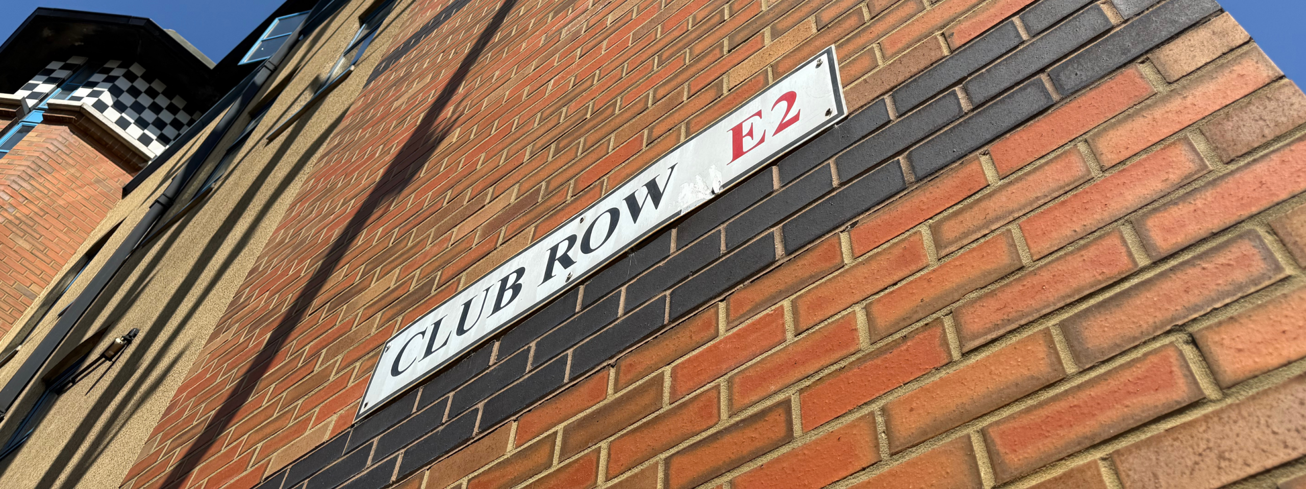 woman smiling by st hildas east history board east london